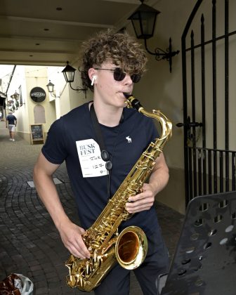 Young male with saxophone.