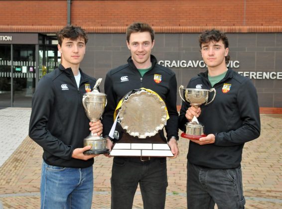 Three males with three trophys.