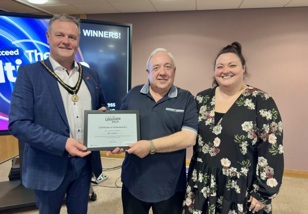 Three people holding a certificate