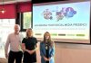 Three people standing in front of a projection screen saying 'Maximising your social media presence'.