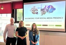 Three people standing in front of a projection screen saying 'Maximising your social media presence'.