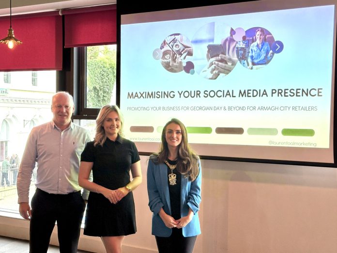 Three people standing in front of a projection screen saying 'Maximising your social media presence'.