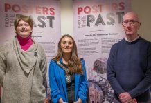 The Lord Mayor Councillor Sarah Duffy is pictured with a female and male in front of pop up banners saying Posters from the Past'. They are pictured together to promote the Posters from the Past Exhibition at Armagh County Museum.