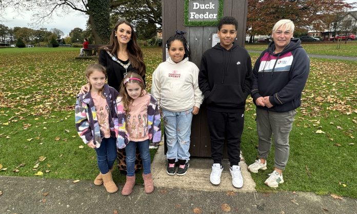 Lord Mayor of ABC Borough, Cllr Sarah Duffy with her daughters Emily and Lucia at the duck feeder in Lurgan Park, with Leanne McShane, Outdoor Spaces Development Officer ABC Council and visitors to the park.