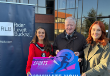 Three people posing with a banner to promote the 2025 senior sports awards.