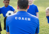 A sports coach taking a children's training session.