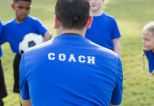 A sports coach taking a children's training session.