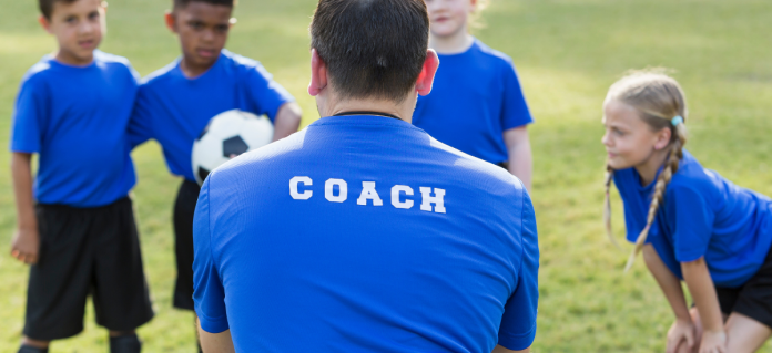 A sports coach taking a children's training session.