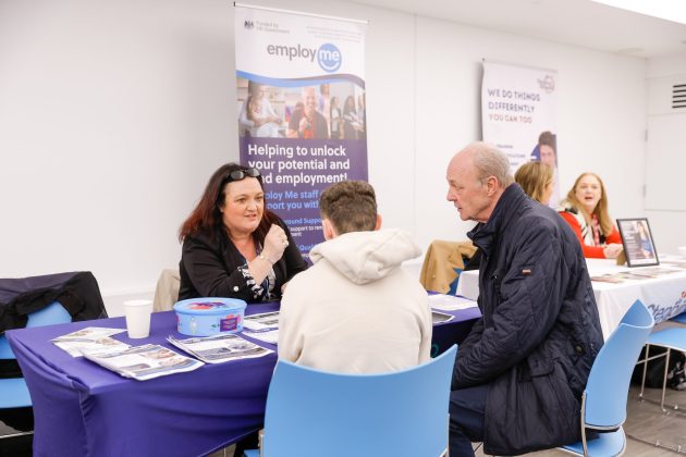 Job seekers talking to employers about job opportunities