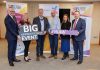 A group of people holding signs which say Big Apprenticeships Event and #NIAW 2025