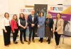 A group of people standing in front of education and food banners at a conference called Grow Together - Regenerating our Borough.