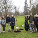 Large group of people outside beside tree