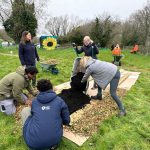 ABC Council staff, NWP staff and volunteers help create the No Dig beds at the Kinnego Bushcraft Community Garden in Oxford Island.