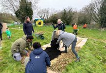 ABC Council staff, NWP staff and volunteers help create the No Dig beds at the Kinnego Bushcraft Community Garden in Oxford Island.