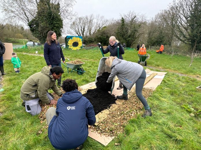 ABC Council staff, NWP staff and volunteers help create the No Dig beds at the Kinnego Bushcraft Community Garden in Oxford Island.